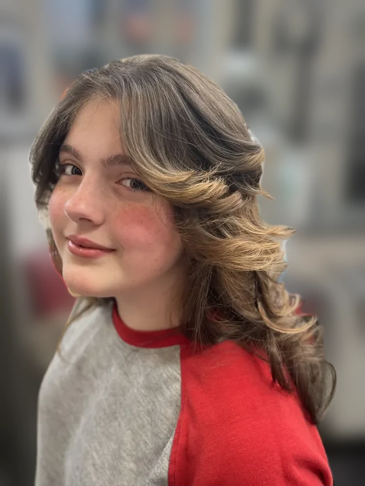 Smiling young client with feathered face-framing layers