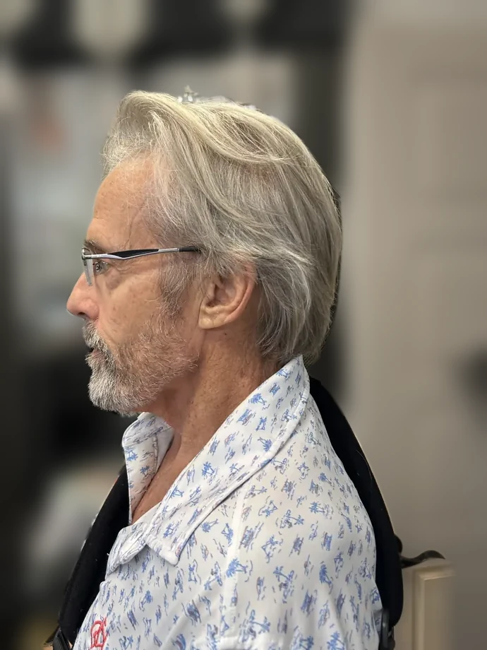Silver-haired gentleman with a fresh cut and tidy beard, profile view