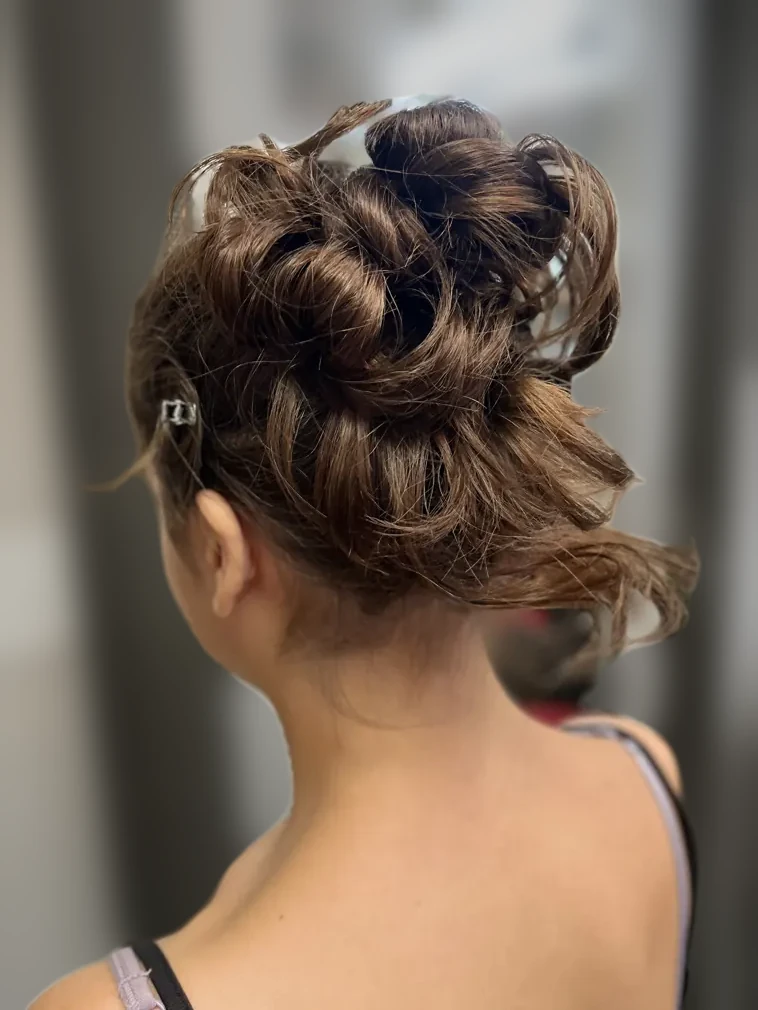 Shoulder-length brunette waves with golden dimension, side view