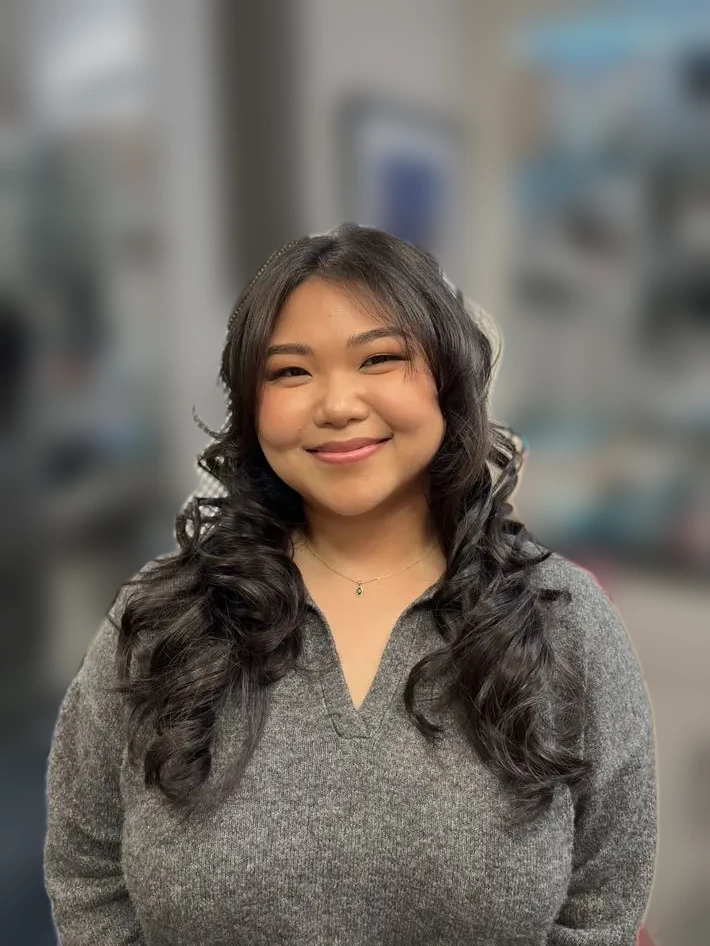 Smiling client with soft face-framing curls