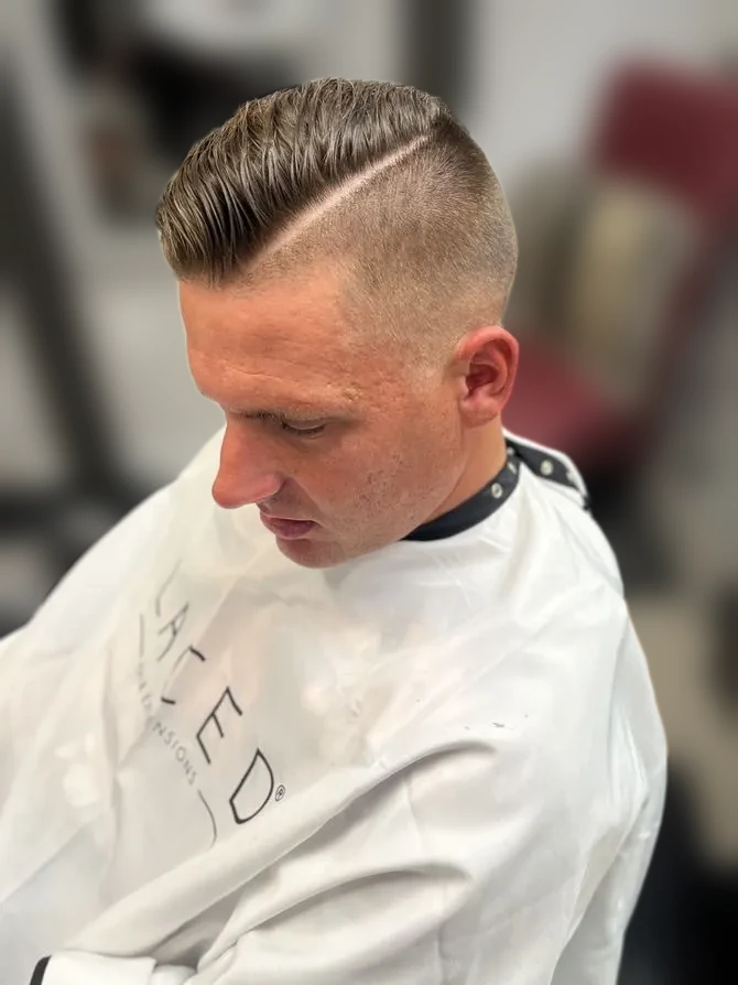 Fade haircut with a hard part