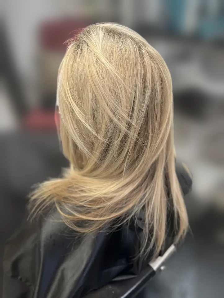 Blonde layered cut with wispy face framing